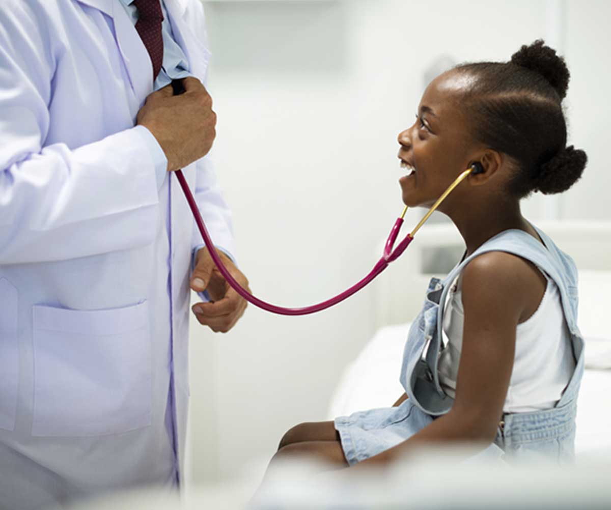 Girl listens to doctor's heart