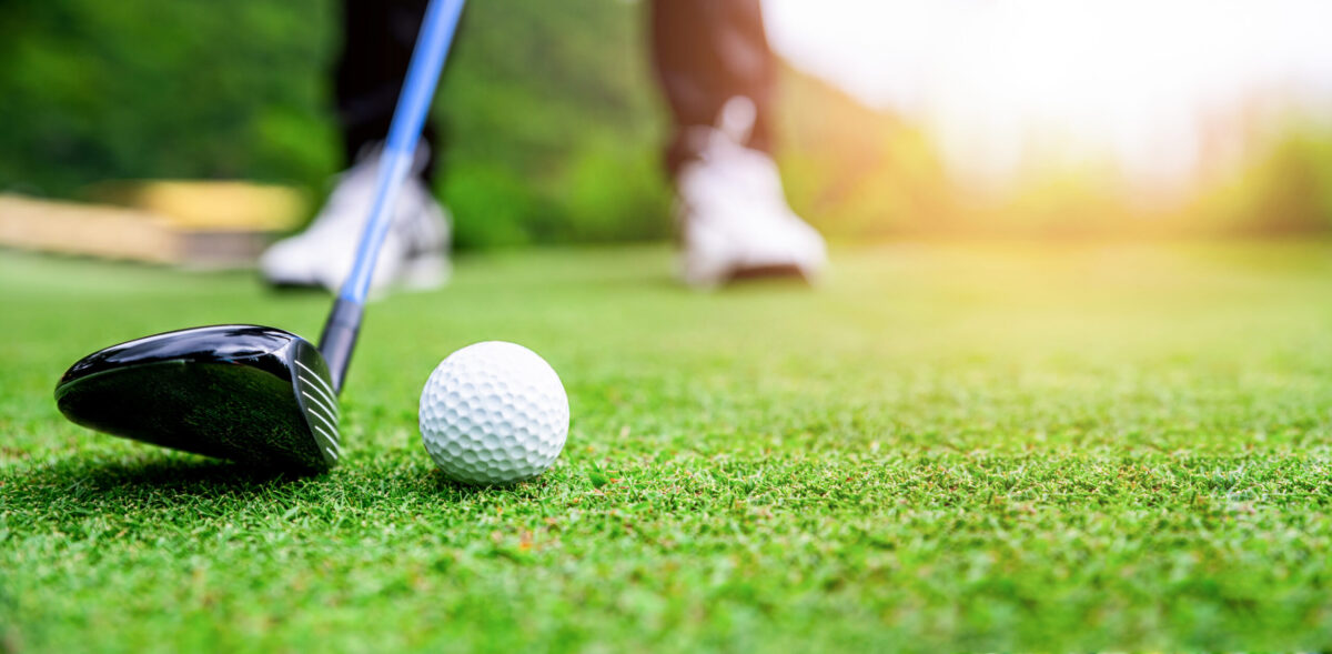 Close up golf ball on green grass field