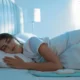 Young woman sleeping on electric heating pad in bed at night