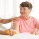 elderly woman working out with the help of a trainer