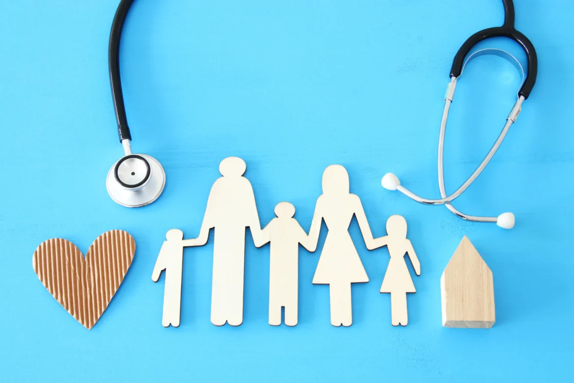 concept image of Stethoscope and family on wooden table