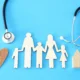 concept image of Stethoscope and family on wooden table