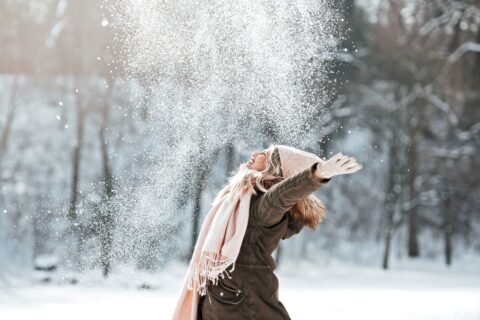 woman playing in the snow