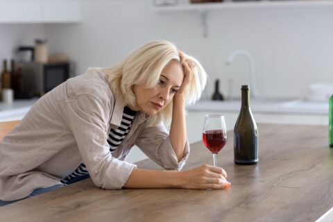 woman drinking wine at home
